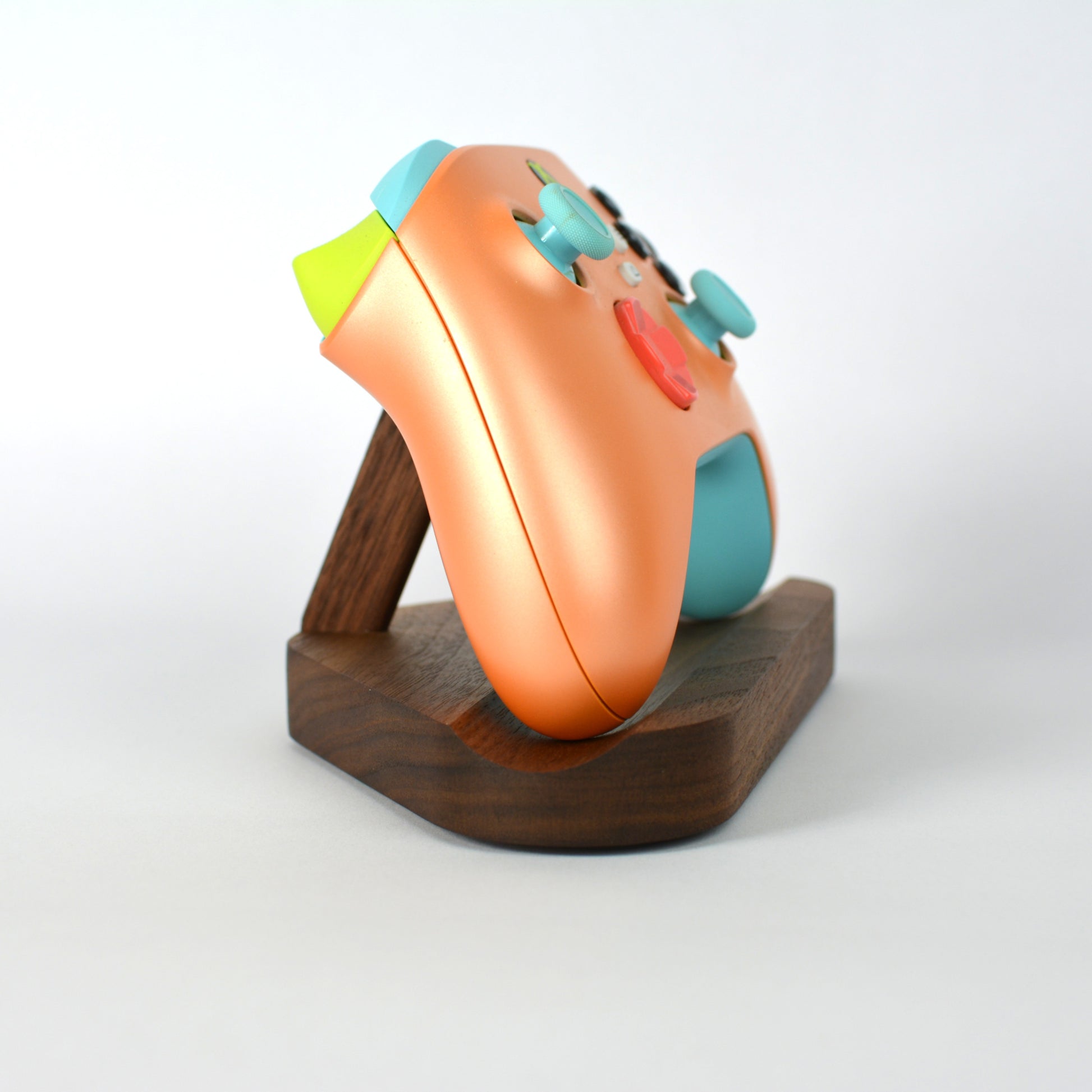 Colorful gaming mouse on a wooden stand with a white background