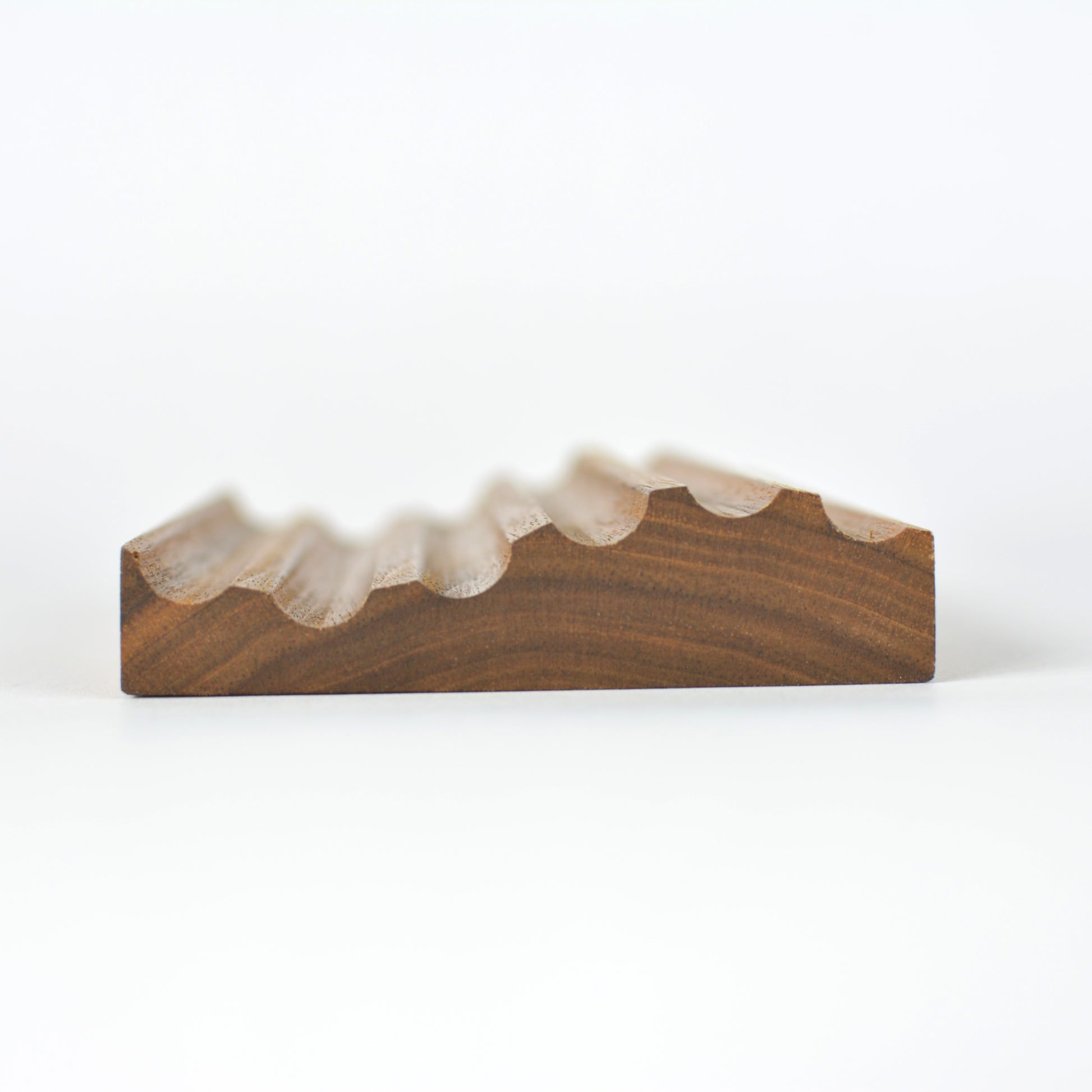 Walnut - profile view of wave pencil tray