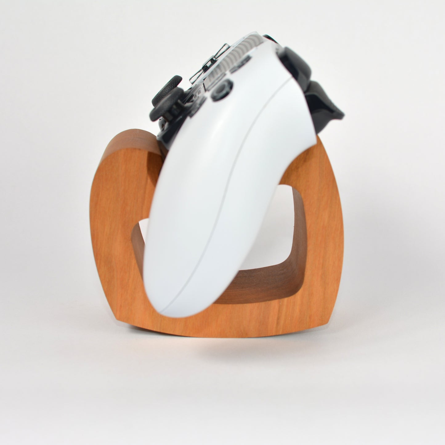 White controller with wooden base on a white background