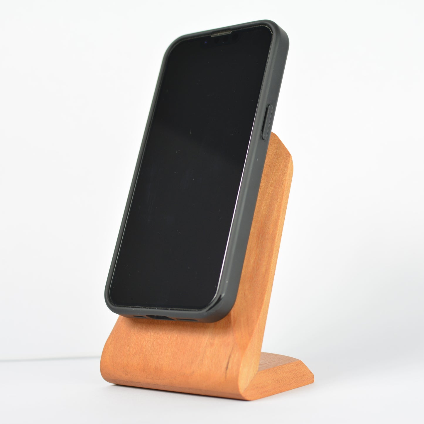 Phone on a wooden stand with a white background