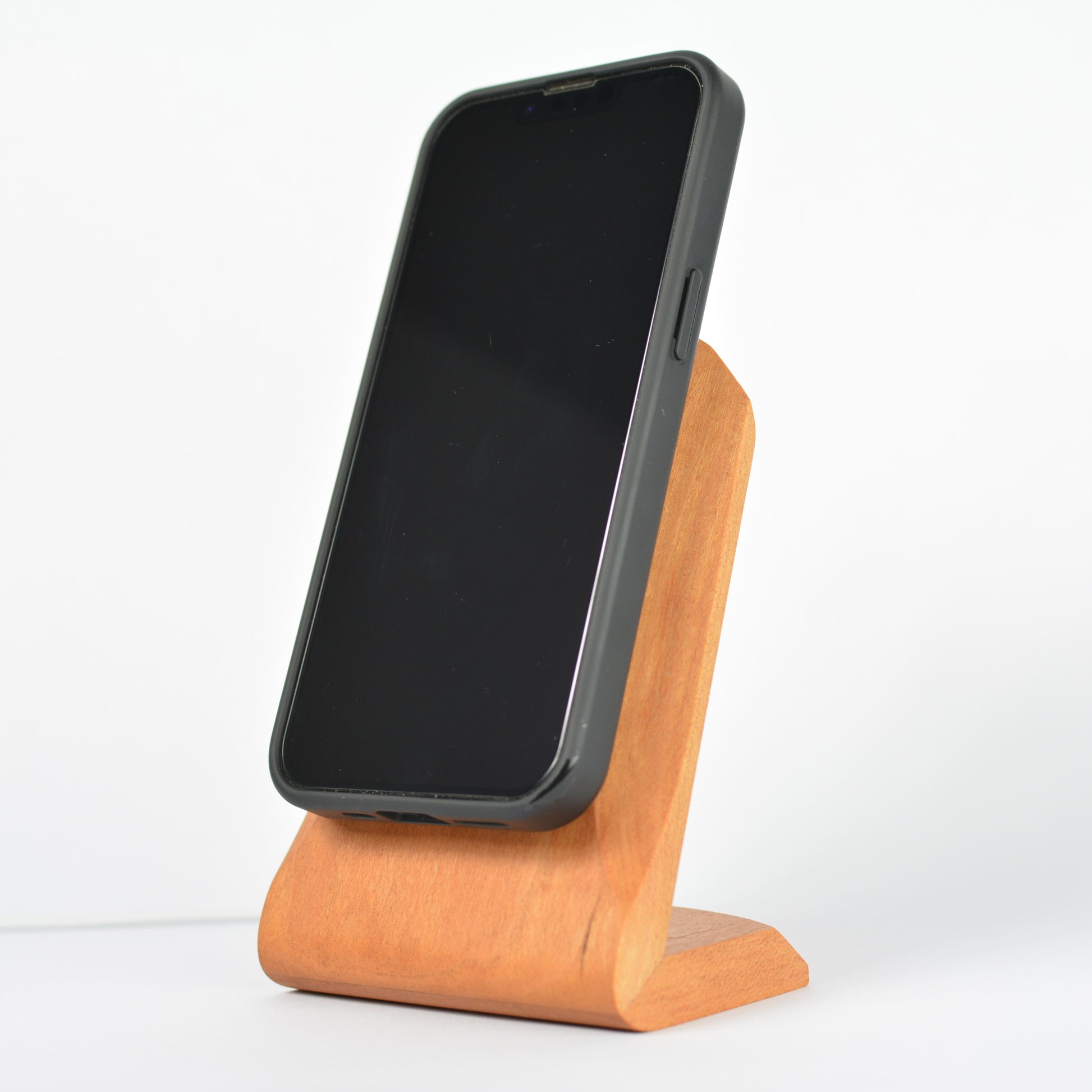 Phone on a wooden stand with a white background