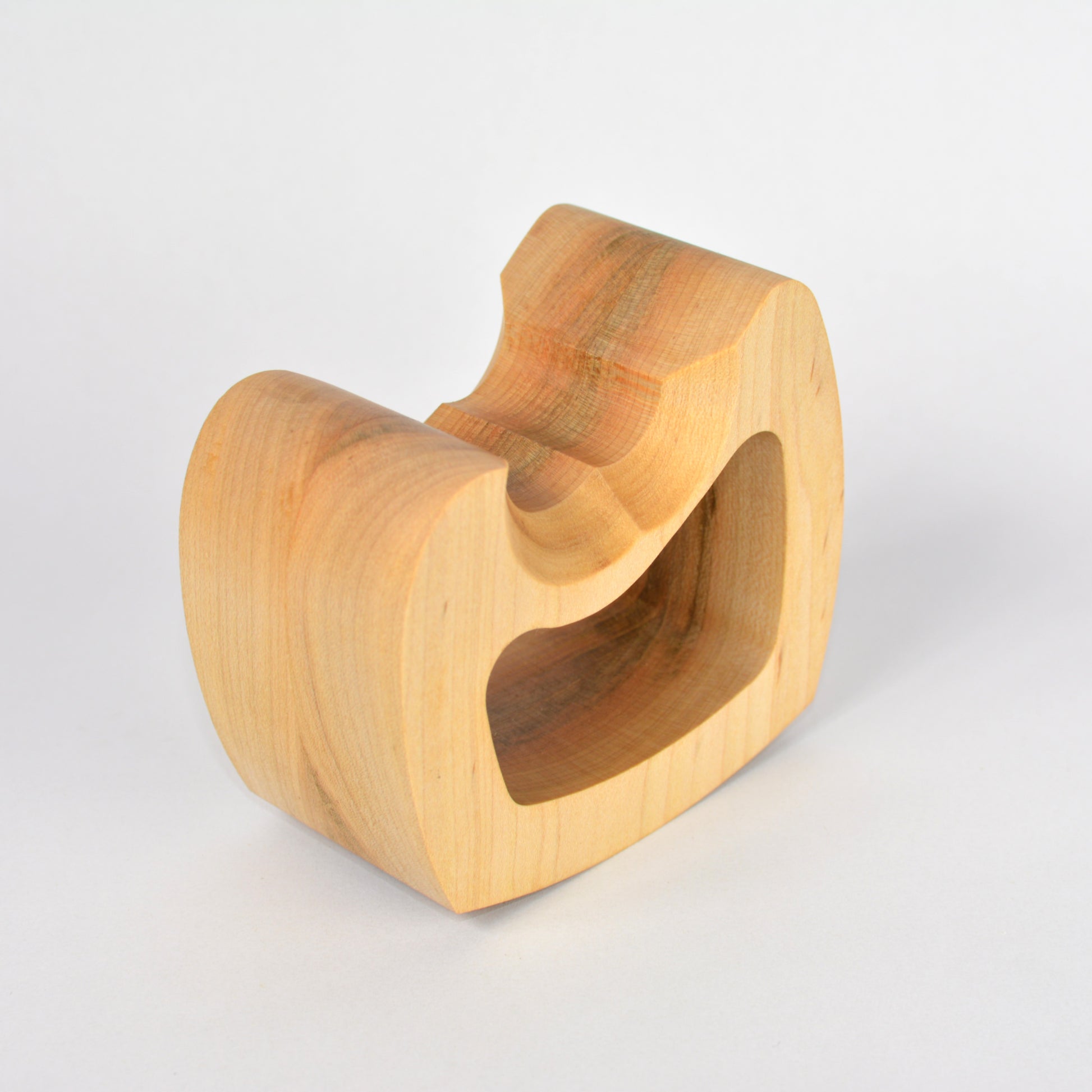 Wooden controller stand with a unique design on a light gray background