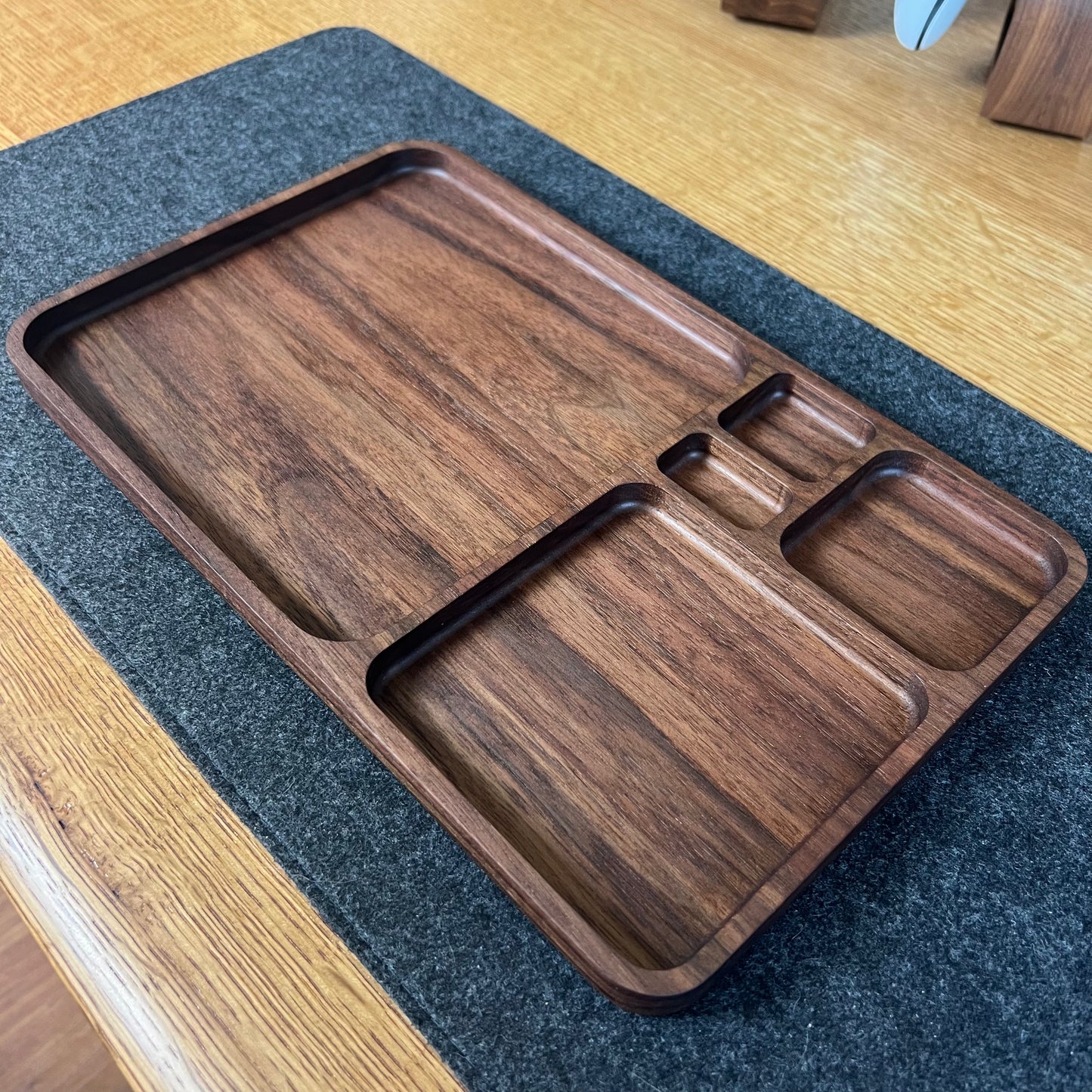 Wooden tray with divided sections on a textured surface
