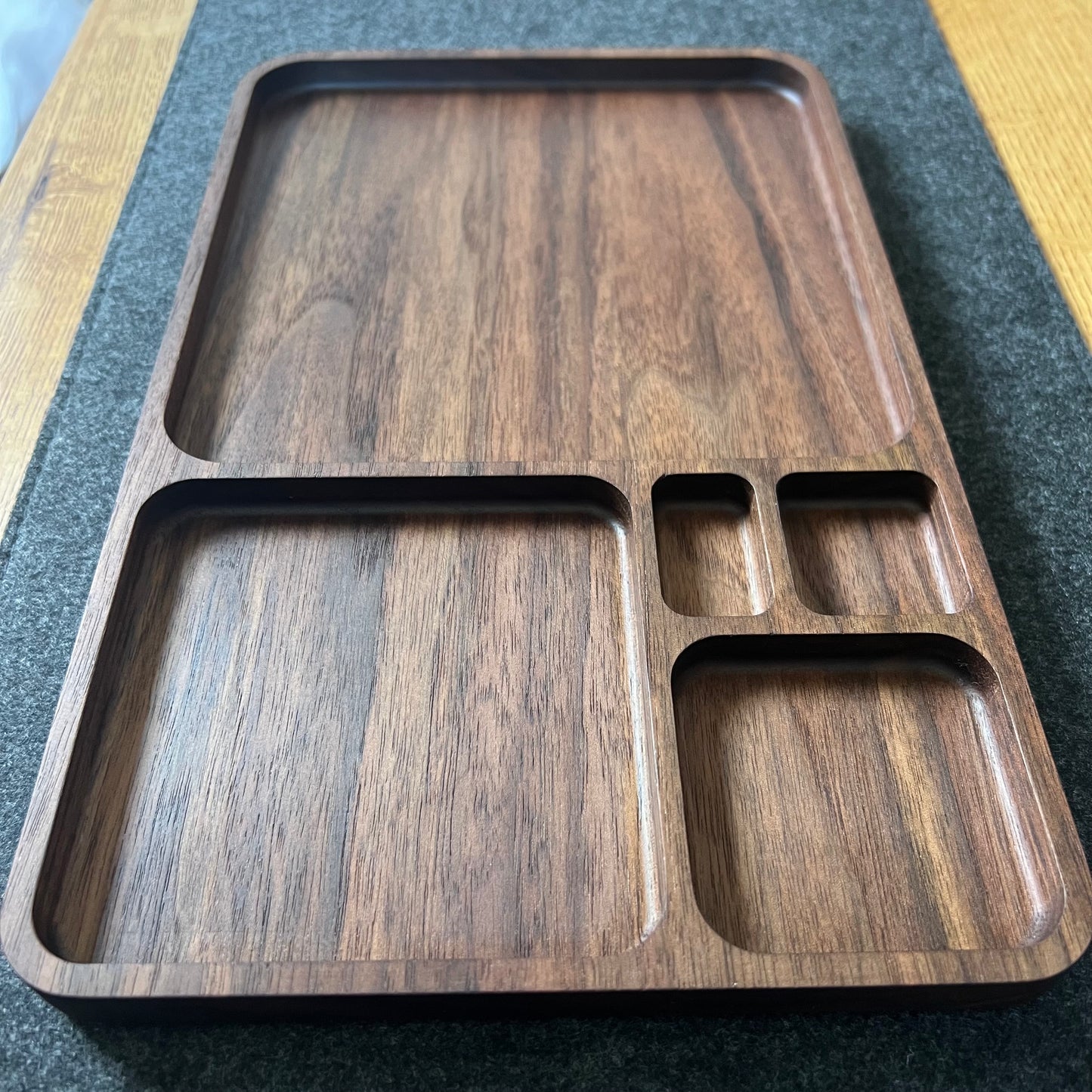 Wooden tray with compartments on a textured surface